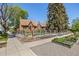Corner lot featuring mature trees, professionally landscaped yard, and hardscape at 1601 Albion St, Denver, CO 80220