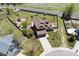 Aerial view of a home with a fenced backyard, playground, mature trees, and a long driveway at 4804 Eckert St, Castle Rock, CO 80104