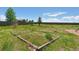 Large backyard featuring overgrown grass, blue sky and old garden beds at 4804 Eckert St, Castle Rock, CO 80104