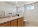 Bathroom featuring a single sink with wooden cabinets and a tiled tub and shower at 4804 Eckert St, Castle Rock, CO 80104