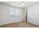 An all-white bedroom filled with natural light, a large window, and plush carpeting at 4804 Eckert St, Castle Rock, CO 80104