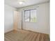 A tidy bedroom with plush carpeting and a window showing a view of the neighborhood at 4804 Eckert St, Castle Rock, CO 80104