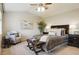 A cozy bedroom featuring a ceiling fan, bedside tables with lamps, and decorative pillows at 4804 Eckert St, Castle Rock, CO 80104