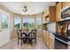 Eat-in kitchen featuring large windows, breakfast nook, and wooden cabinetry at 4804 Eckert St, Castle Rock, CO 80104