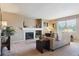 Comfortable living room featuring a fireplace, neutral decor, and natural light at 4804 Eckert St, Castle Rock, CO 80104