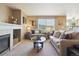 Cozy living room with a fireplace, neutral walls, and large window at 4804 Eckert St, Castle Rock, CO 80104