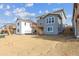 Rear view of two-story home with backyard space ready for landscaping at 25273 E Warren Pl, Aurora, CO 80018