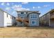 Rear exterior view of home, showcasing its deck and providing yard space at 25273 E Warren Pl, Aurora, CO 80018