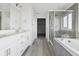 Stylish bathroom with double vanity, soaking tub, and glass shower at 25273 E Warren Pl, Aurora, CO 80018