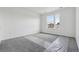 Well-lit bedroom with carpet and large windows overlooking the neighborhood at 25273 E Warren Pl, Aurora, CO 80018