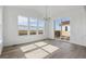 Bright dining area with large windows, a chandelier, and sliding glass doors leading to the outdoor deck at 25273 E Warren Pl, Aurora, CO 80018