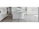 Modern kitchen featuring a large island, white cabinetry, stainless steel appliances, and an open layout at 25273 E Warren Pl, Aurora, CO 80018