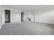 Open living room area featuring doorways and neutral carpeting at 25273 E Warren Pl, Aurora, CO 80018