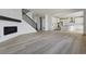 Spacious living area with hardwood floors, fireplace, staircase, and open access to the modern kitchen at 25273 E Warren Pl, Aurora, CO 80018