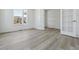 Light-filled office space with large windows, light gray flooring, and French doors leading to another room at 25273 E Warren Pl, Aurora, CO 80018