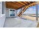 Concrete patio provides a transition to the yard, and stairs lead to the upper deck at 25273 E Warren Pl, Aurora, CO 80018
