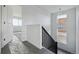 Bright stairway features dark wood banister, white walls, and natural light at 25273 E Warren Pl, Aurora, CO 80018