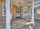 Inviting front porch with white railings, brick facade, and decorative iron door at 453 S Lincoln St, Denver, CO 80209