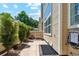 View of side yard featuring patio, landscaping, private entrance and exterior faucet at 5704 W Atlantic Pl, Lakewood, CO 80227