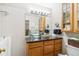 Bright bathroom featuring clear sink bowl, custom tile and cabinets, plus great lighting at 5704 W Atlantic Pl, Lakewood, CO 80227