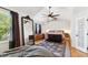 Comfortable bedroom boasts neutral tones, large window, and stylish ceiling fan for a calming retreat at 5704 W Atlantic Pl, Lakewood, CO 80227