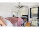 This light filled bedroom has large windows, a dark metal bed frame and a fan at 5704 W Atlantic Pl, Lakewood, CO 80227