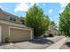 Exterior view of home featuring attached garages, neutral siding, and manicured landscaping at 5704 W Atlantic Pl, Lakewood, CO 80227