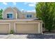 Exterior view of home featuring attached garage, neutral siding, and manicured landscaping at 5704 W Atlantic Pl, Lakewood, CO 80227