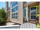 Close up exterior of tan townhome featuring beautiful windows, walkway to the front door, and charming landscaping at 5704 W Atlantic Pl, Lakewood, CO 80227