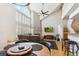 Bright living room features soaring ceilings, oversized windows, fireplace, and modern decor for comfortable living at 5704 W Atlantic Pl, Lakewood, CO 80227