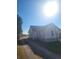 Exterior view of a simple house showcasing a well-kept lawn and a peaceful rural setting at 254 Donna St, Fort Lupton, CO 80621