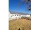 Rear exterior view of a charming home featuring a classic design and simple backyard at 254 Donna St, Fort Lupton, CO 80621
