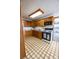 This kitchen includes wood cabinets, white appliances, a drop-in sink, and a patterned floor at 254 Donna St, Fort Lupton, CO 80621