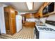 Efficient kitchen features wood cabinetry, a built-in microwave, and a gas range at 254 Donna St, Fort Lupton, CO 80621