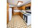A practical kitchen featuring wood cabinets, essential appliances, and a durable floor design at 254 Donna St, Fort Lupton, CO 80621