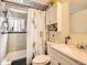Bathroom featuring a shower-tub combo with a sunflower shower curtain, a vanity, and a mirror at 6837 S Brook Forest Rd, Evergreen, CO 80439