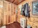 Spacious wood-paneled closet featuring built-in storage, rod for hanging, and hardwood floors at 6837 S Brook Forest Rd, Evergreen, CO 80439