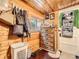 Walk-in closet featuring wood-paneled walls, a dresser, and hanging storage, offering ample space at 6837 S Brook Forest Rd, Evergreen, CO 80439