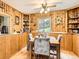 Cozy dining room with wood-paneled walls, creating a warm and inviting atmosphere at 6837 S Brook Forest Rd, Evergreen, CO 80439