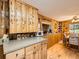 Charming wood-paneled kitchen featuring ample counter space, wood cabinets, and a dining area at 6837 S Brook Forest Rd, Evergreen, CO 80439