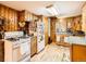 Charming kitchen with wood cabinets, a gas range, and a cozy, functional layout at 6837 S Brook Forest Rd, Evergreen, CO 80439