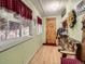 Bright mud room with wood floors and a unique bar area for added convenience at 6837 S Brook Forest Rd, Evergreen, CO 80439