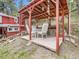 Outdoor patio area with a red pergola and outdoor furniture at 6837 S Brook Forest Rd, Evergreen, CO 80439