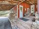 Inviting covered patio area with stone accents, offering a cozy outdoor retreat at 6837 S Brook Forest Rd, Evergreen, CO 80439