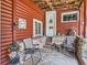 Cozy front porch with charming decor and seating, offering a welcoming entrance at 6837 S Brook Forest Rd, Evergreen, CO 80439