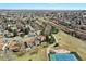 Beautiful aerial view of a home near a tennis court, park and green space at 7761 Everett Way, Arvada, CO 80005