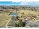 Aerial community view highlighting the tennis court, walking path, and picturesque surroundings at 7761 Everett Way, Arvada, CO 80005