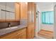 Bathroom including wooden cabinets, granite countertop, and modern fixtures at 7761 Everett Way, Arvada, CO 80005