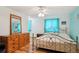 This bedroom features light colored walls, hardwood floors, and a metal frame bed at 7761 Everett Way, Arvada, CO 80005