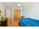 This bedroom features light colored walls, hardwood floors, and a large closet at 7761 Everett Way, Arvada, CO 80005